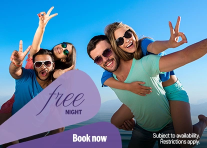 Free night hotel offer featuring a group of friends having fun on a sunny day.